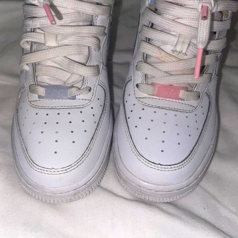 These are Nike 1 shoes kids white, pink, and blue air forces